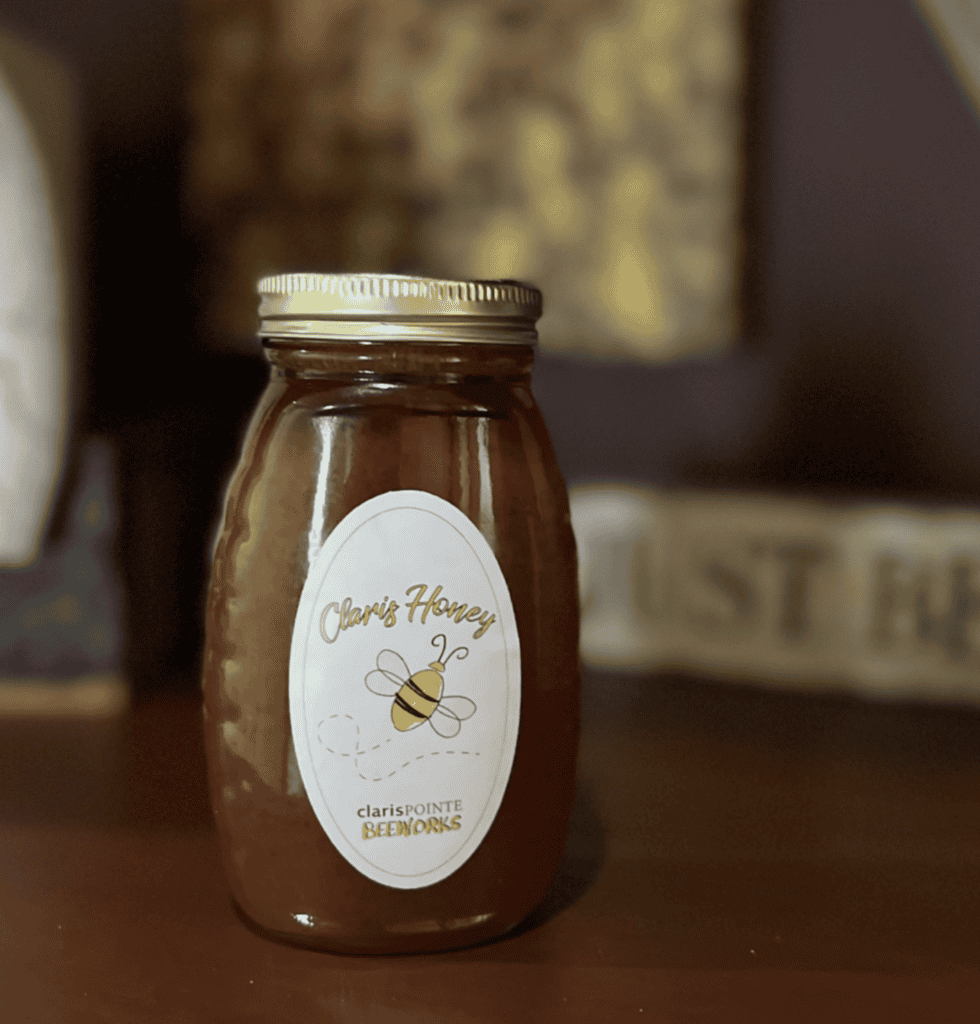 A jar of “Claris Honey” rests on a dark surface, evoking the sense of clarity often found through legal mediation.